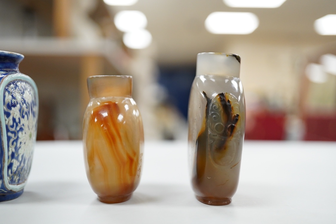 Three 19th century Chinese agate snuff bottles and a porcelain snuff bottle, largest 6cm high (4)